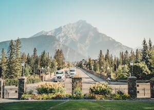 A picturesque view of Banff Avenue with a stunning mountain backdrop, showcasing nature and urban life.