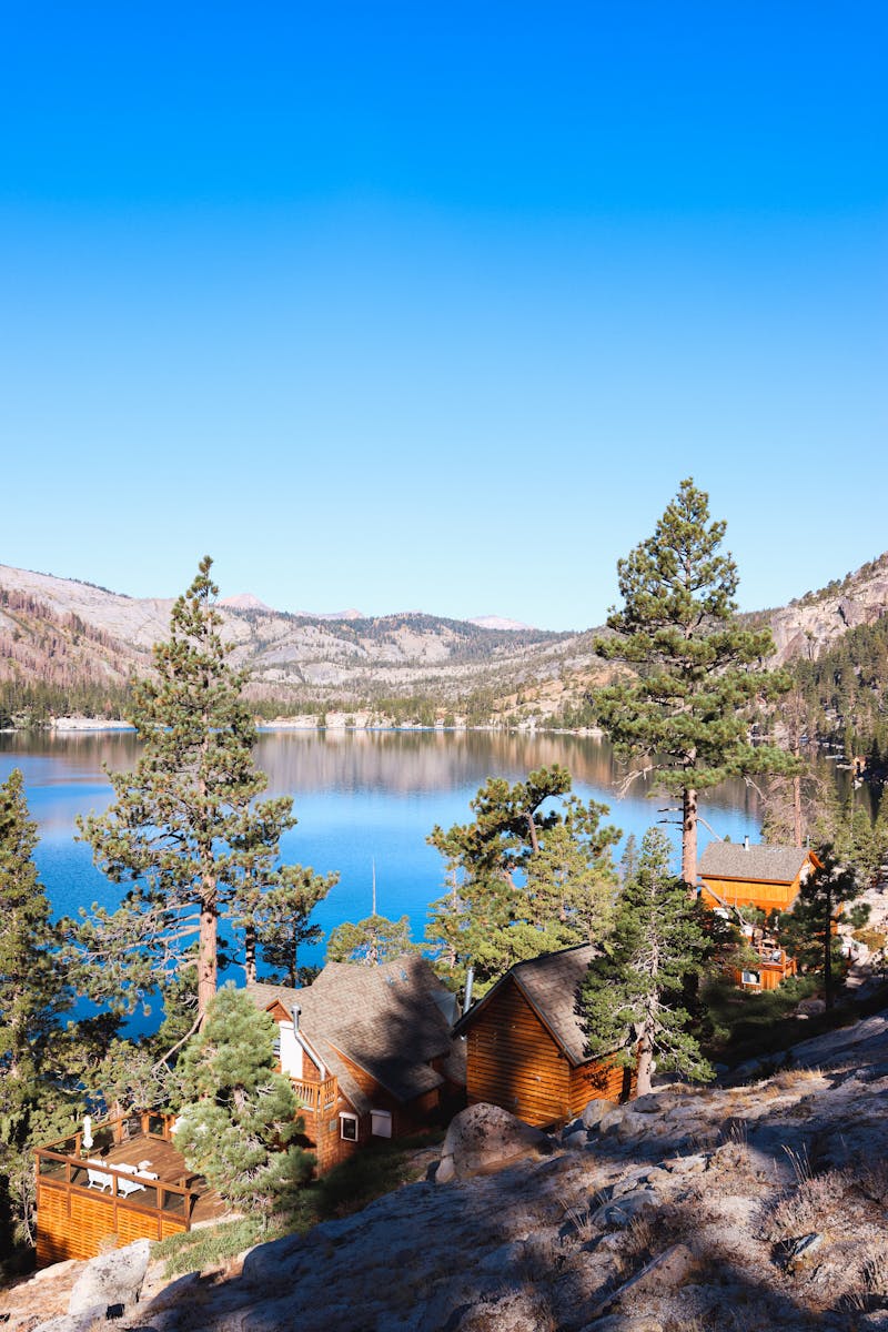 How to Choose a Lake Tahoe CAbin for Families: A Summer Guide 8 Beautiful view of Echo Lake with mountain cabins, clear blue skies, and pine trees in summer.