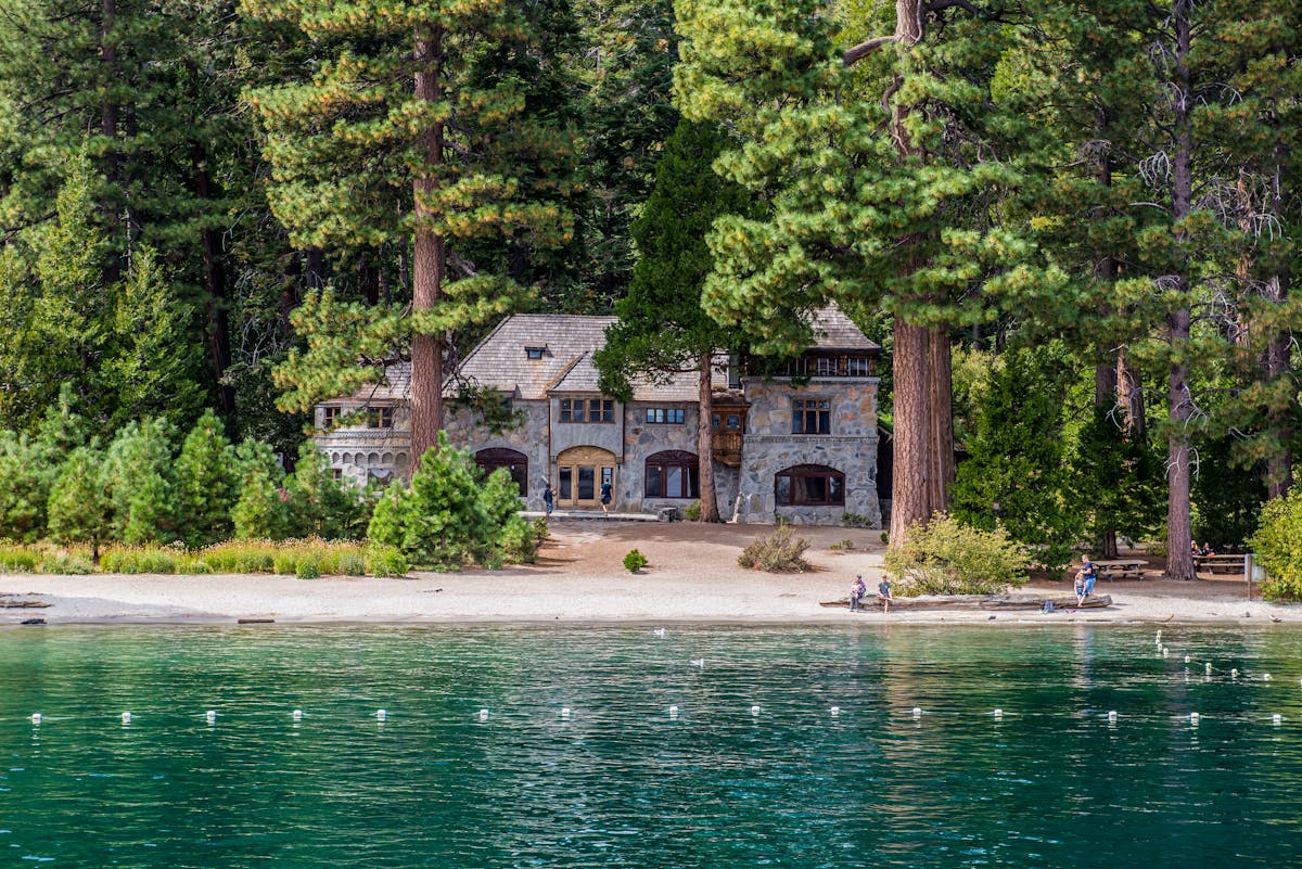27 Best Things to Do in Lake Tahoe with Kids (Beaches, Hikes & Easy Family Activities) 12 Vikingsholm Castle nestled by a tranquil lakeshore surrounded by lush greenery.